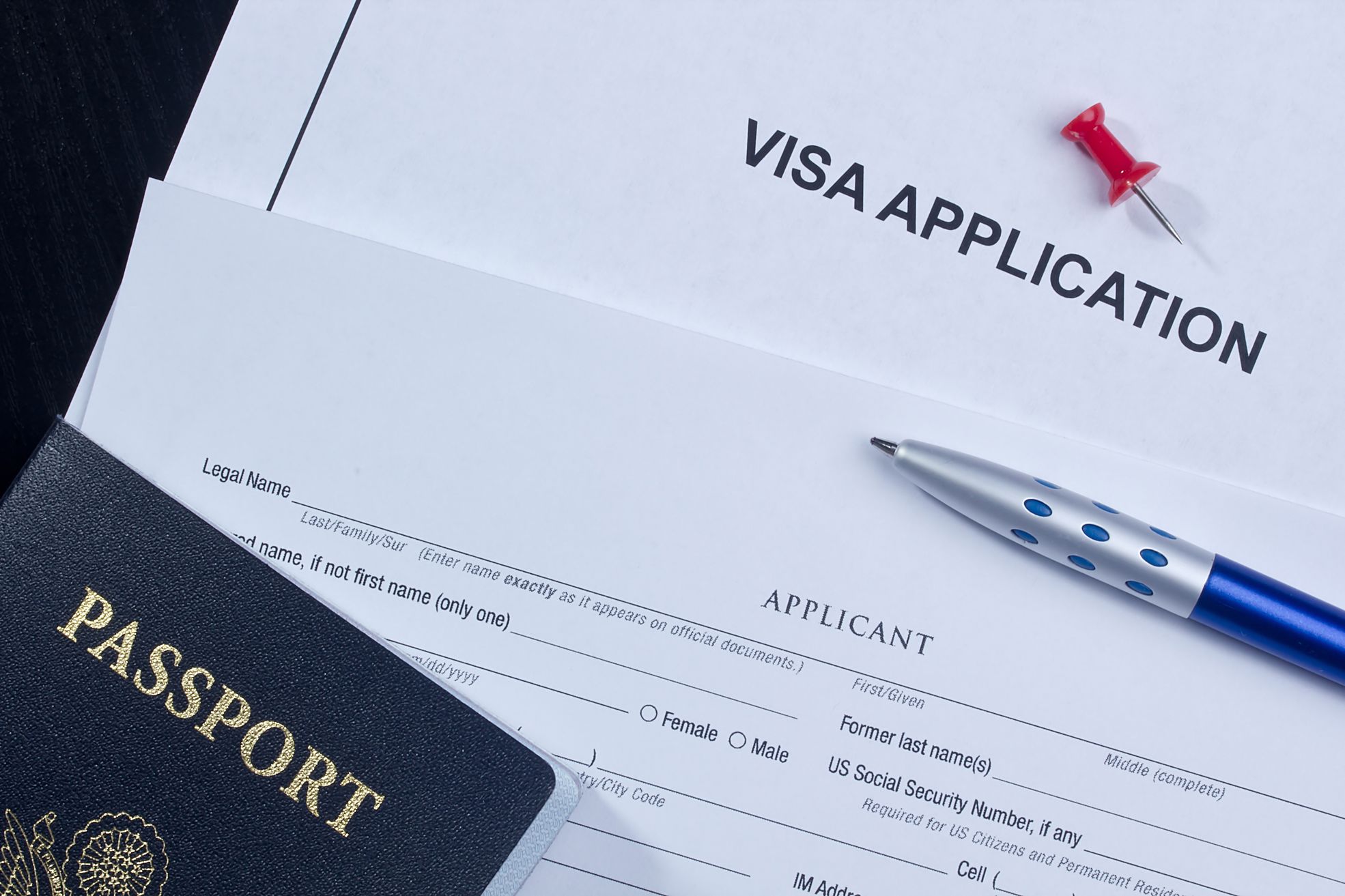 A close-up of a visa application and an upper part of a US passport
