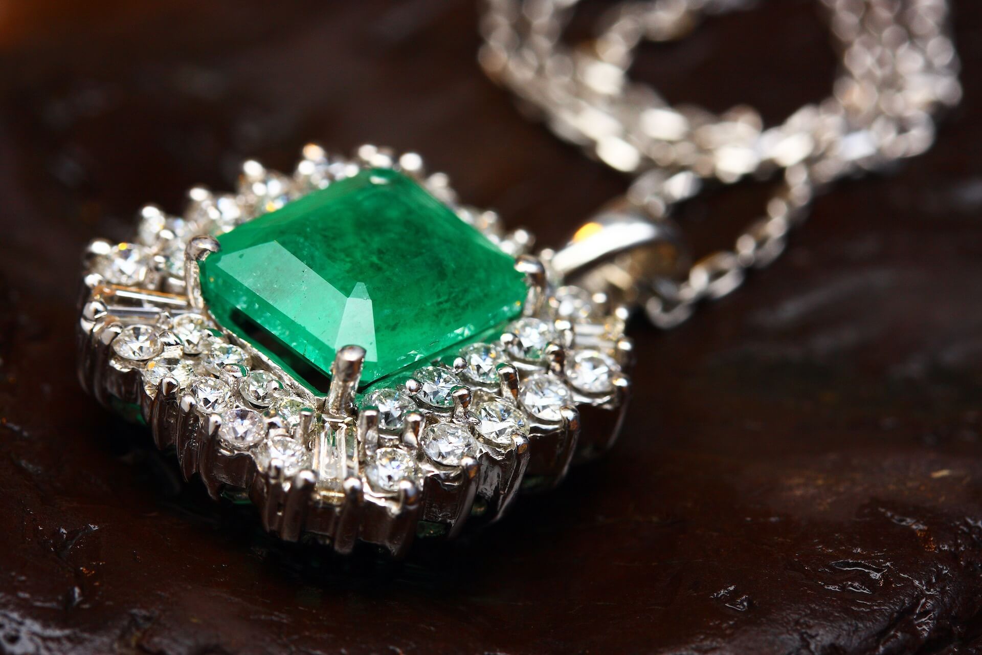 Silver-colored pendant with green gemstone