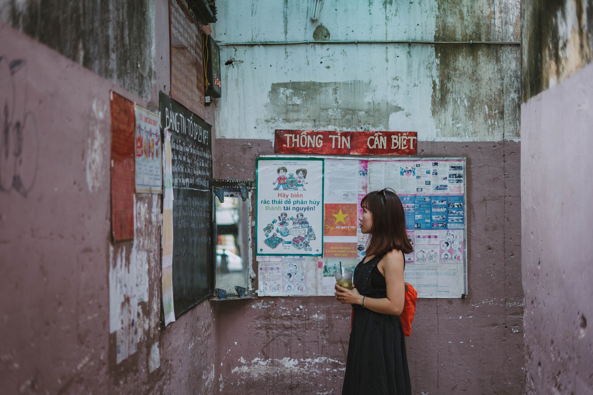 A woman reading street flyers in Thailand