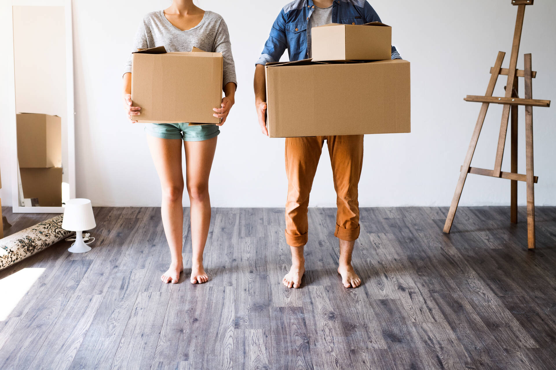 Two people holding boxes