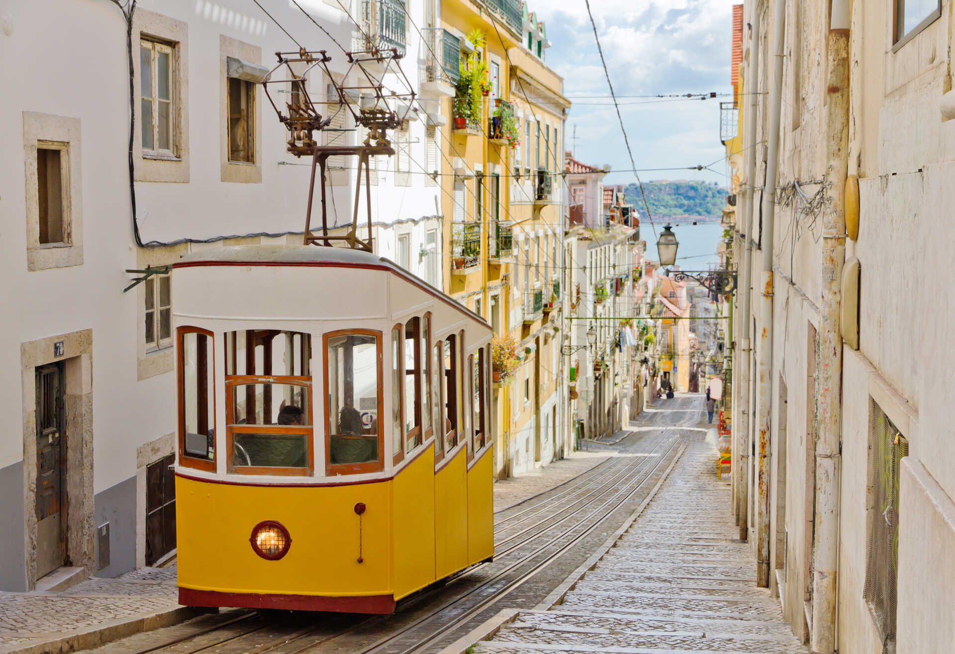 Yellow tram in the narrow street