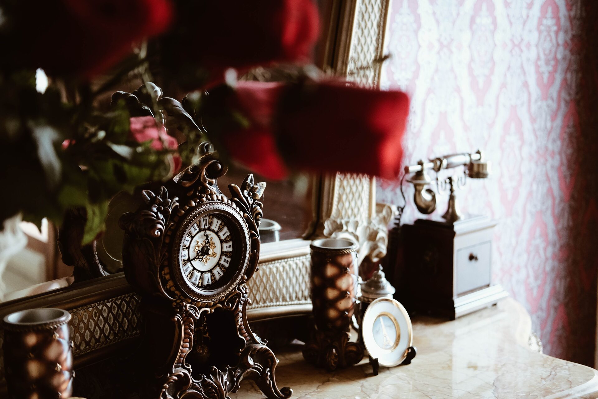 Old clock and telephone in front of a mirror