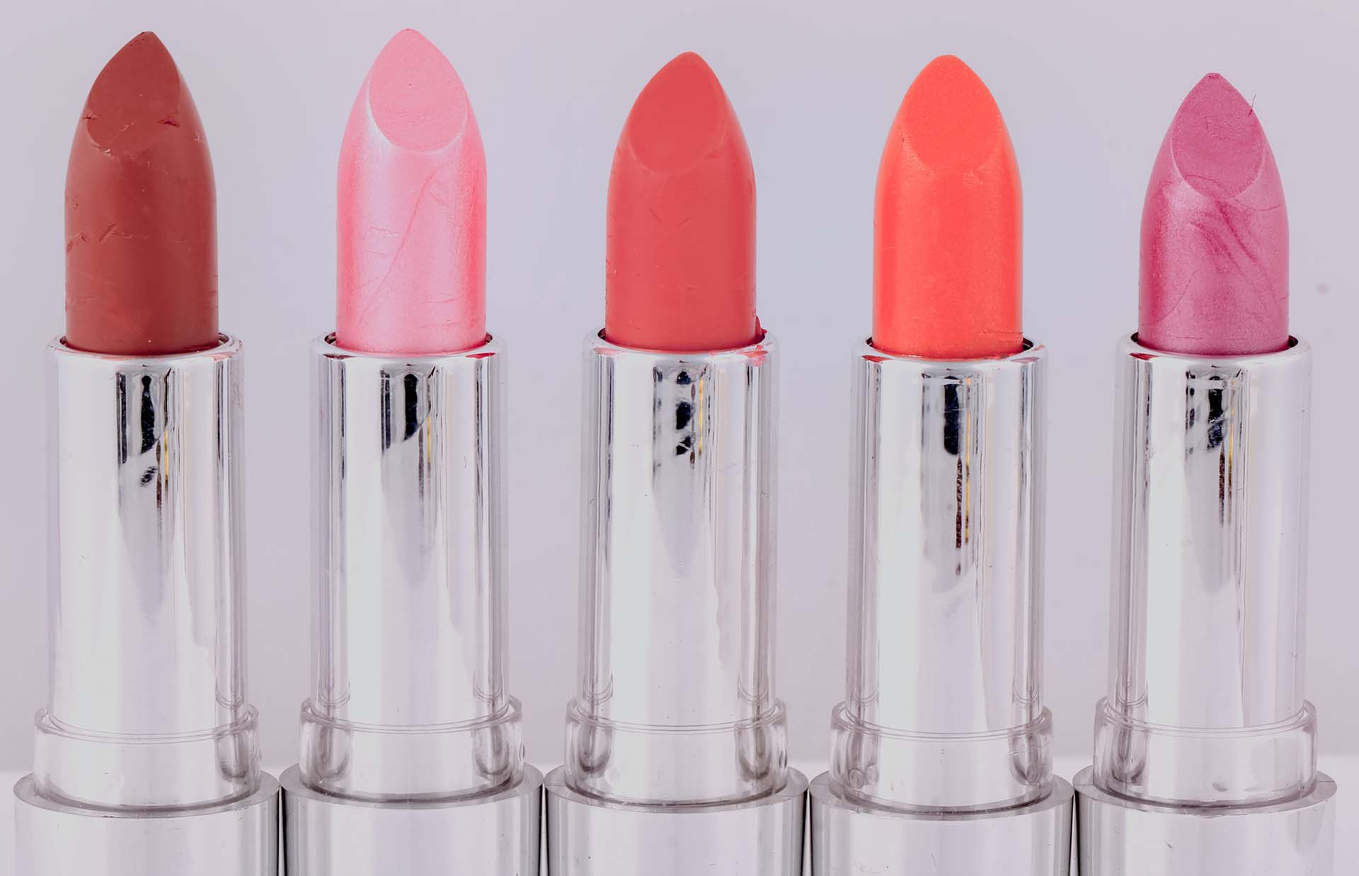 A close-up of five lipsticks