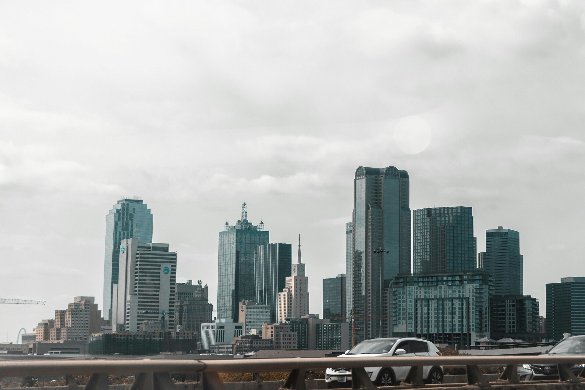 View of the Dallas skyline from a highway bridge at sunset